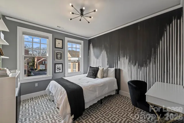 a bedroom with a bed and a large window