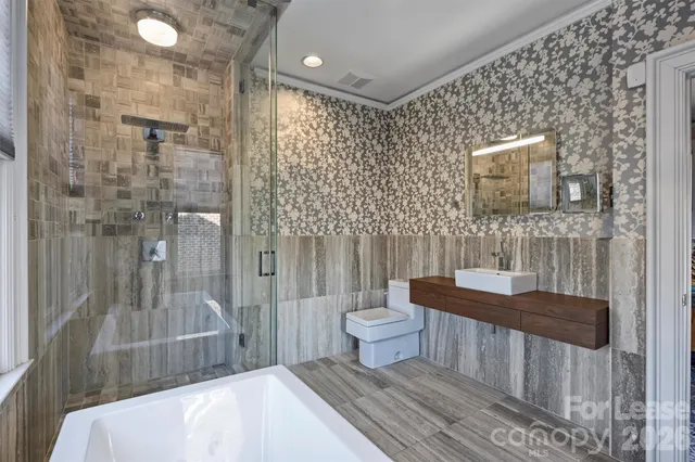 a bathroom with a toilet and a shower