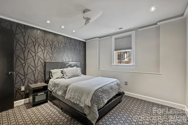 a bedroom with a bed and a night stand