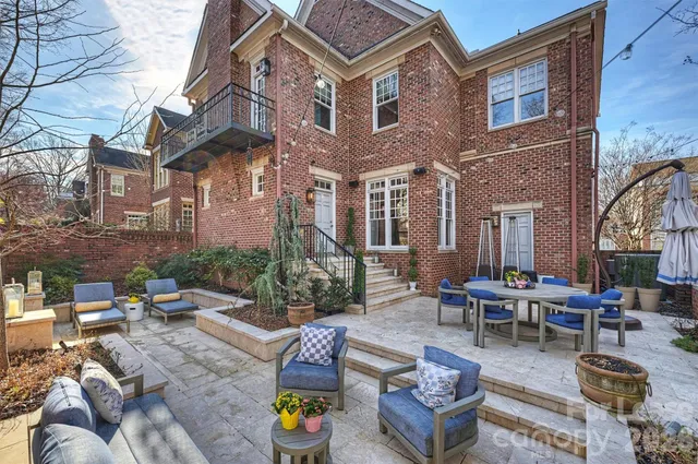 a view of a patio with couches table and chairs and potted plants
