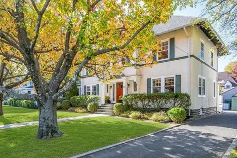 a front view of house with yard and green space
