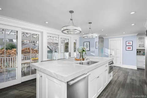 a very nice looking dining room with wooden floor and a chandelier