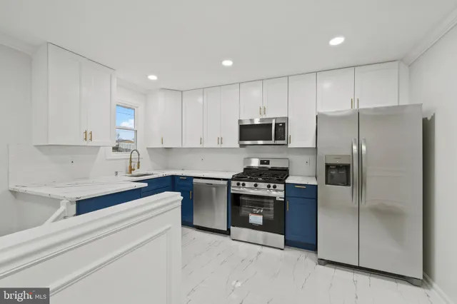 a kitchen with a refrigerator sink and stainless steel appliances
