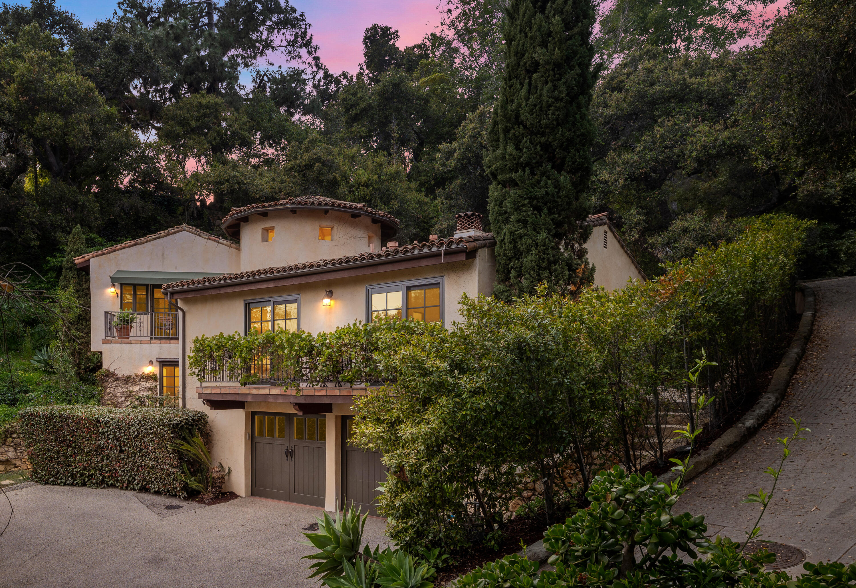 a front view of a house with a garden