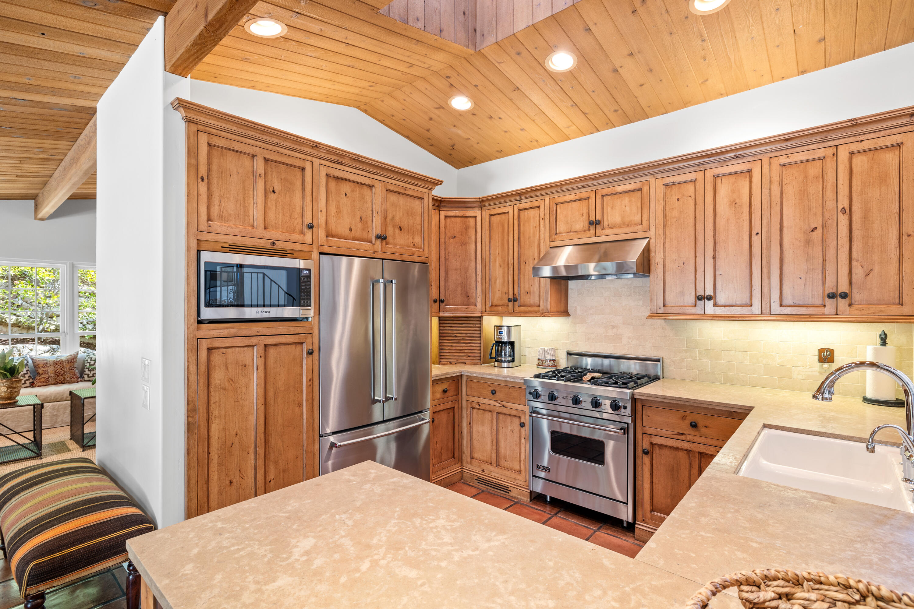 853 Jimeno Road Santa Barbara, CA 93103 - Photo 13 of 27 a kitchen with stainless steel appliances granite countertop a stove a refrigerator a sink dishwasher and wooden cabinets with wooden floor