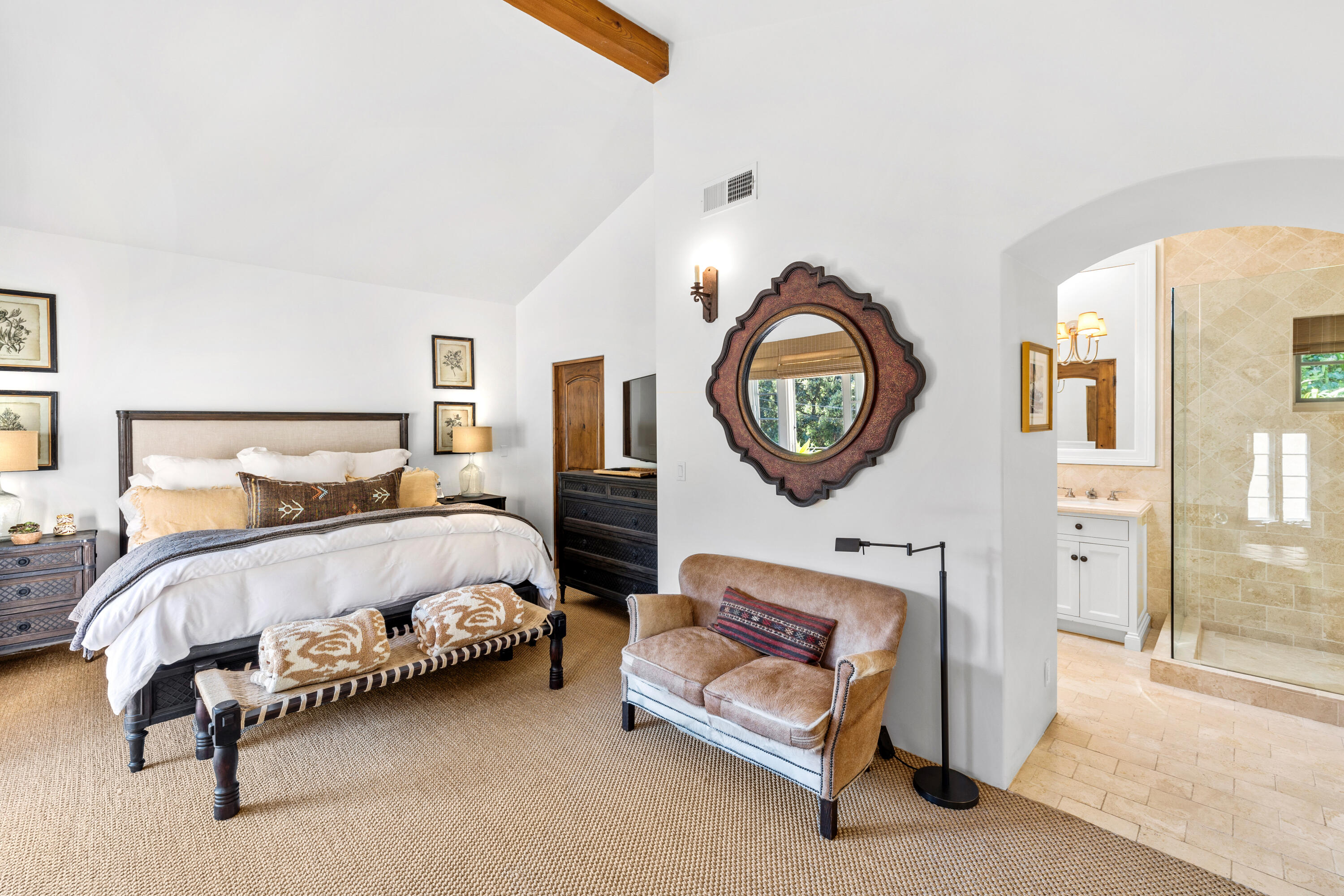 853 Jimeno Road Santa Barbara, CA 93103 - Photo 18 of 27 a spacious bedroom with a bed a mirror and a large window