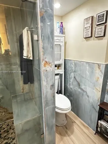 a white toilet sitting next to a bathroom sink
