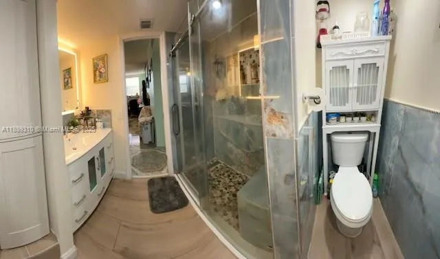a bathroom with a sink a toilet and shower