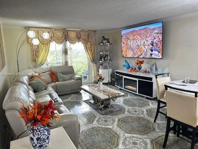a living room with furniture city view and a window