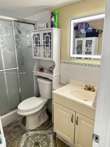 a bathroom with a sink toilet and shower