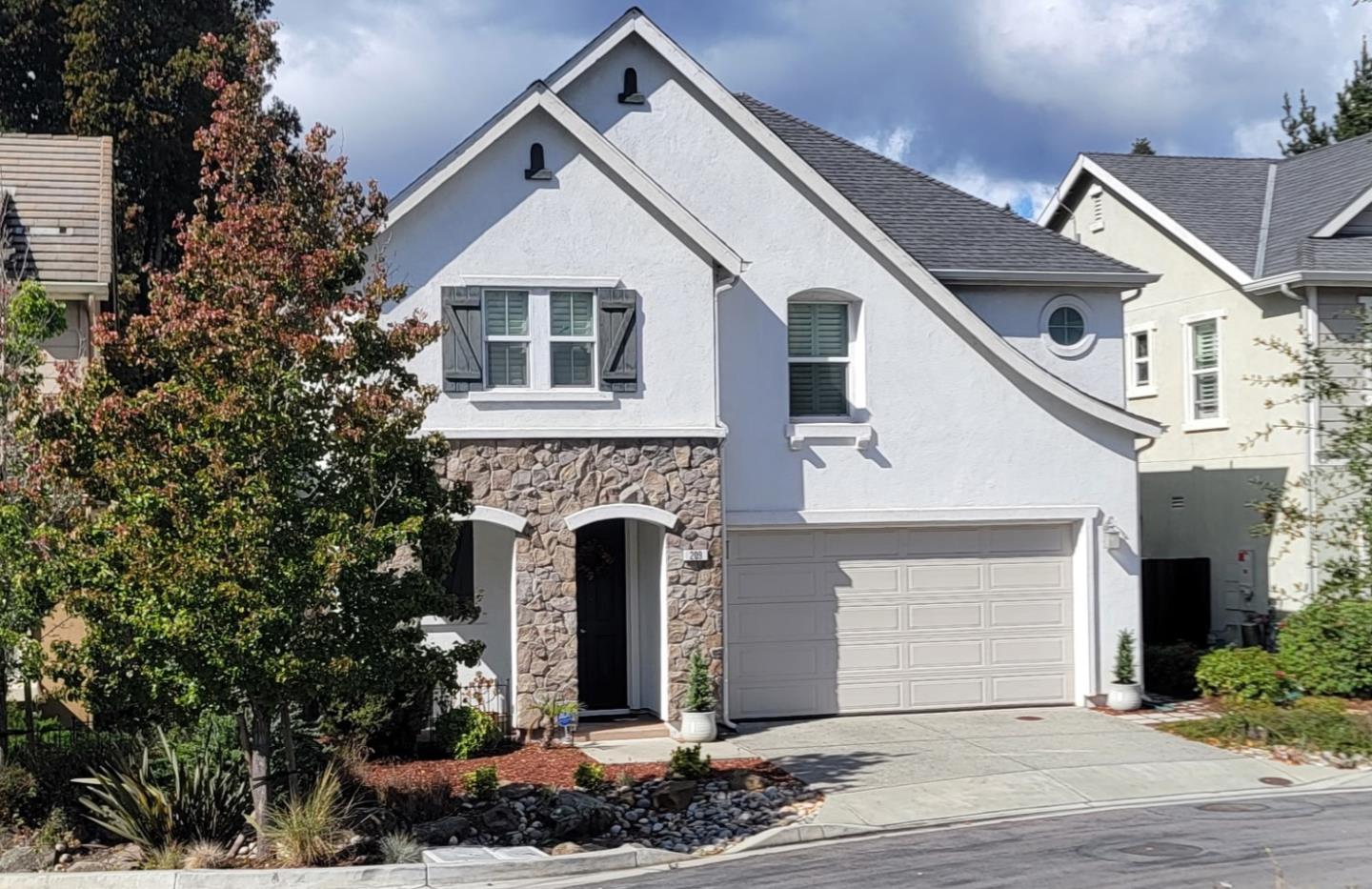 a front view of a house with a garden