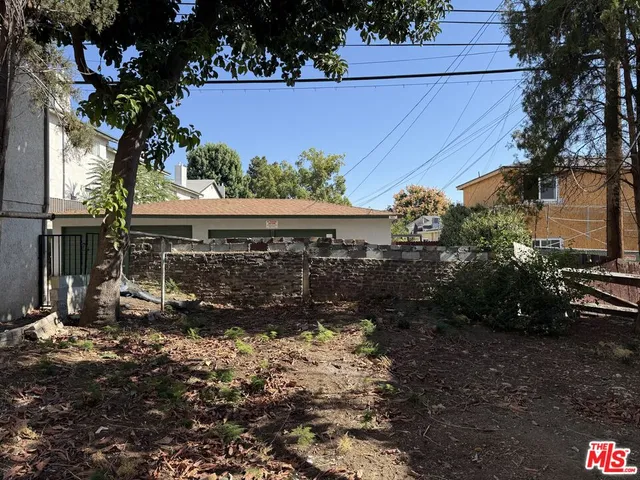 a view of house with wooden fence