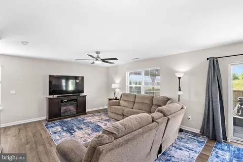 a dining room with furniture and a floor to ceiling window