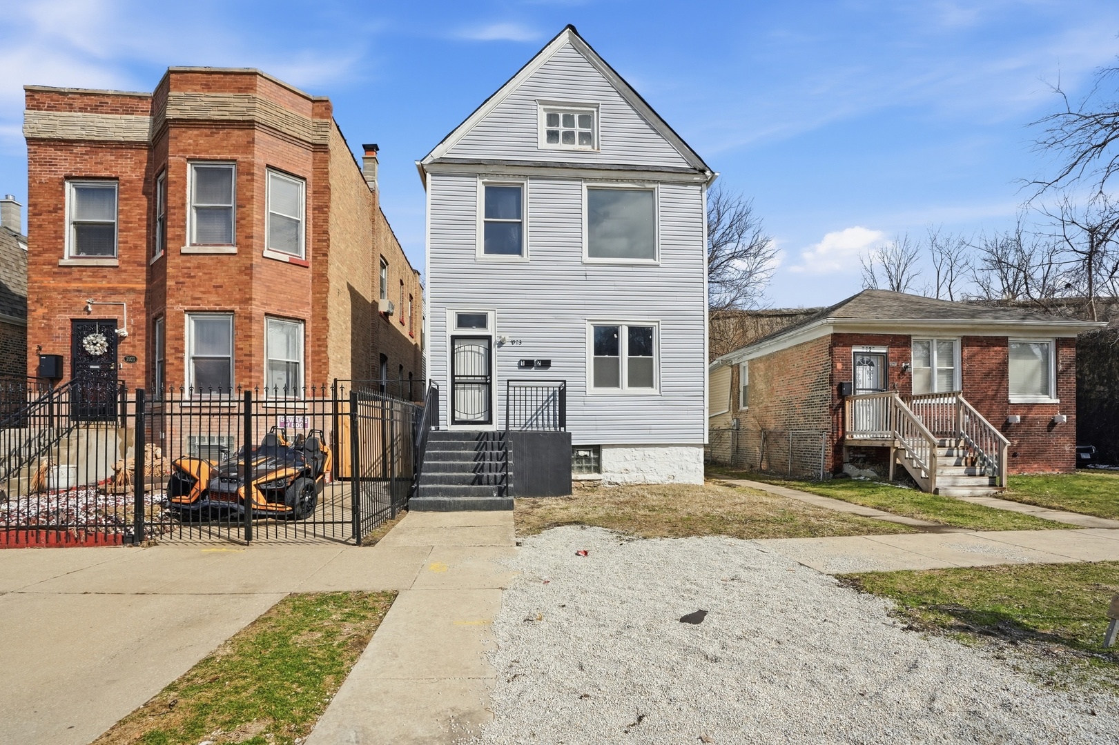 a front view of a house with a yard outdoor seating and garage