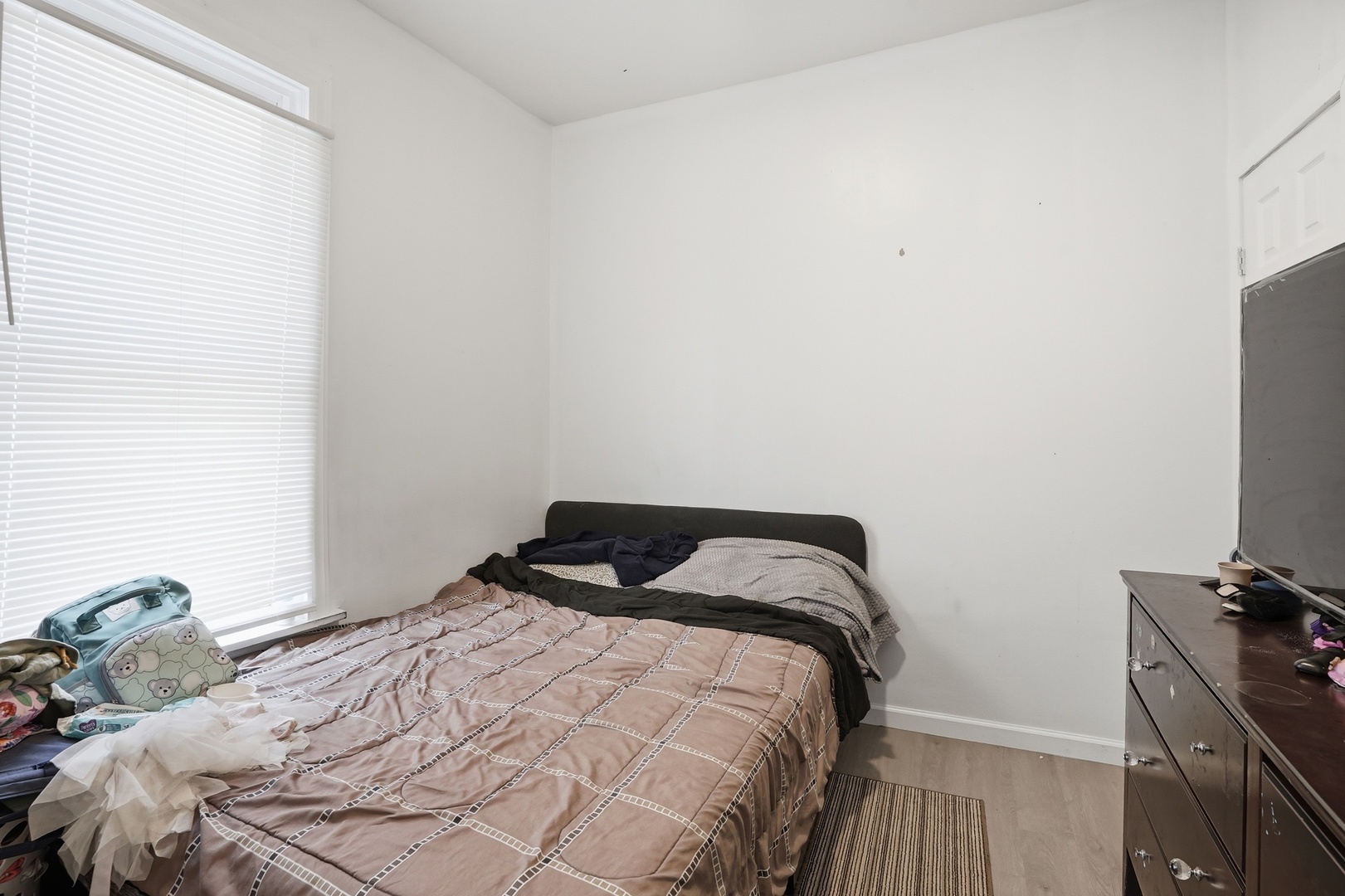 7923 South Lowe Avenue Chicago, IL 60620 - Photo 18 of 23 a bedroom with a bed and a flat tv screen on the dresser