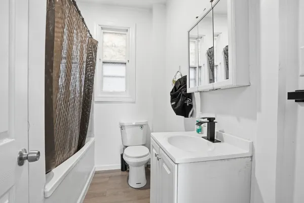 a bathroom with a toilet sink and mirror