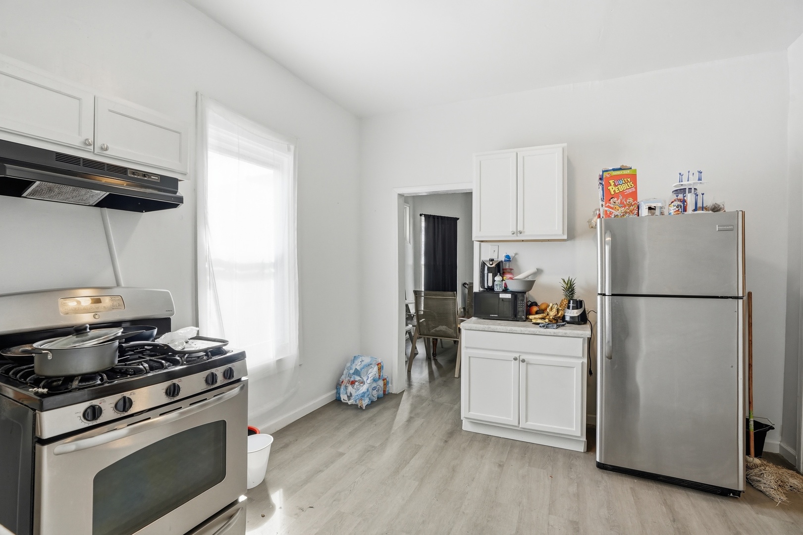 7923 South Lowe Avenue Chicago, IL 60620 - Photo 7 of 23 a kitchen with a refrigerator a stove a sink and cabinets