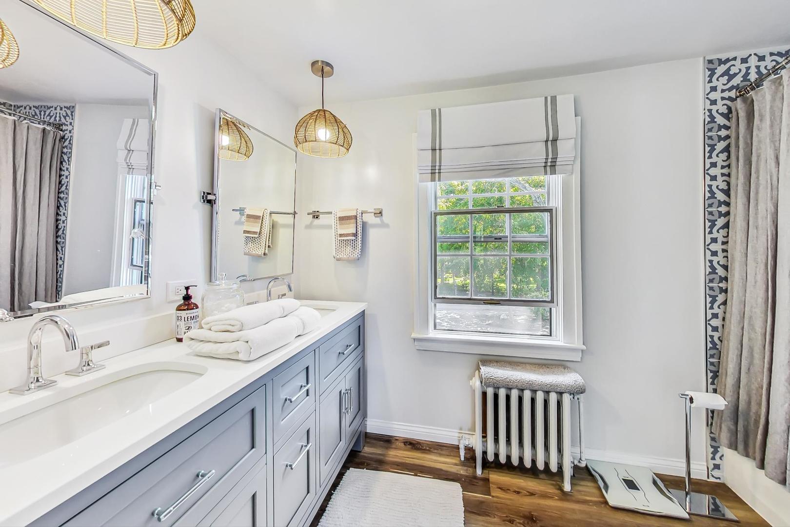 12 Timber Lane Northbrook, IL 60062 - Photo 16 of 28 a bathroom with a double vanity sink and a window