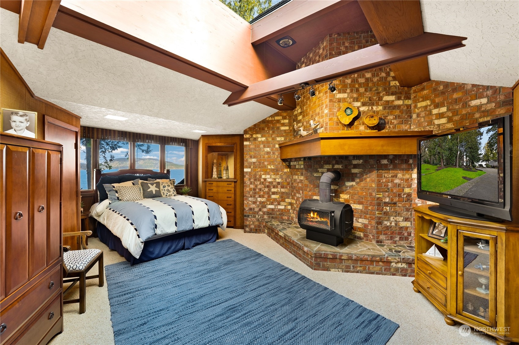 3559 Biz Point Road Anacortes, WA 98221 - Photo 24 of 37 a bedroom with a bed and wooden floor