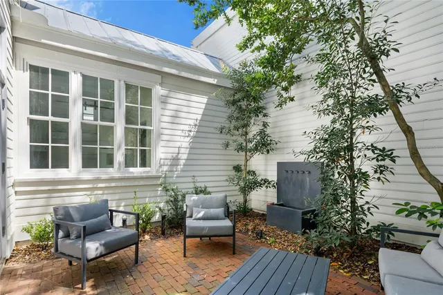 a balcony with furniture and a potted plant