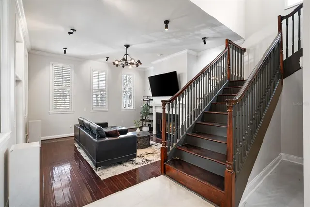 a living room with furniture and a chandelier