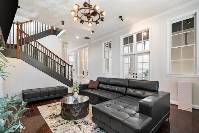 a living room with furniture and wooden floor
