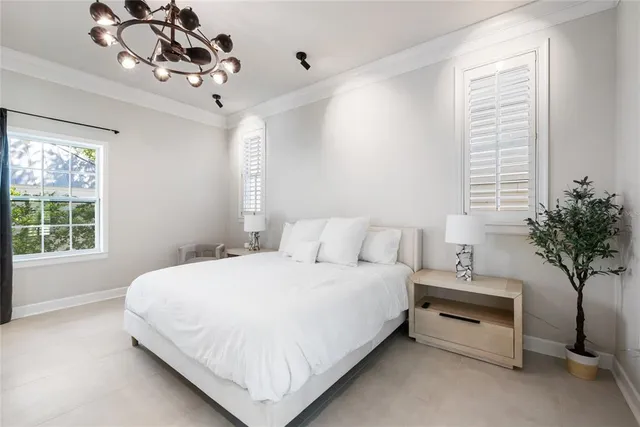 a bedroom with a bed and a potted plant