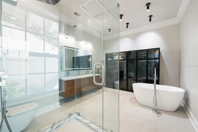 a bathroom with a tub and a glass door shower