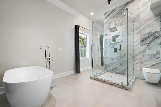 a bathroom with a bathtub and shower