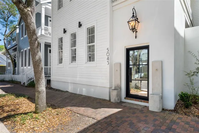 a view of a brick house with many windows