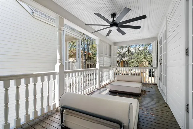 a view of a porch with wooden floor and a ceiling fan