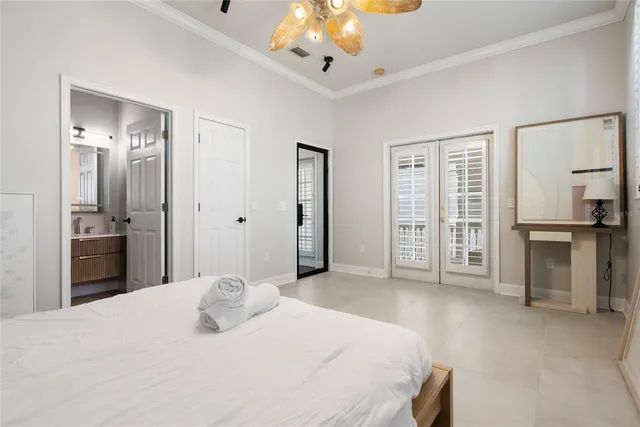 a bedroom with a bed and a chandelier