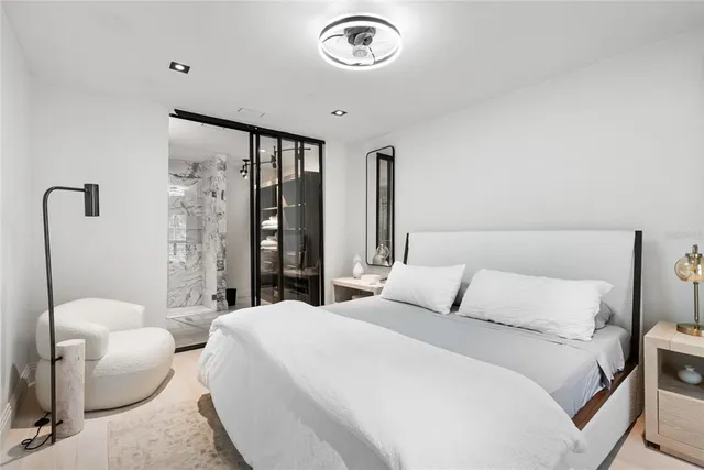 a bedroom with a bed and a chandelier