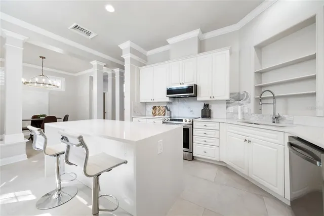 a kitchen with appliances a sink and cabinets