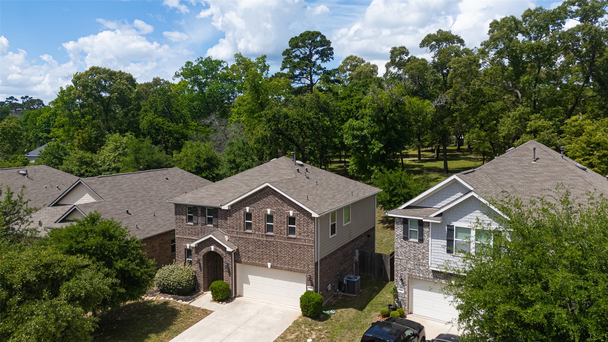 2107 Parnevik Place Conroe, TX 77304 - Photo 40 of 44 Enjoy a serene backyard escape with a fully fenced yard that opens to a stunning stretch of mature trees—your own private slice of nature just beyond the fence line.