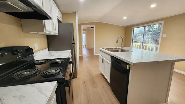 a kitchen with a sink stove and cabinets