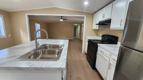 a kitchen with a sink a stove and refrigerator