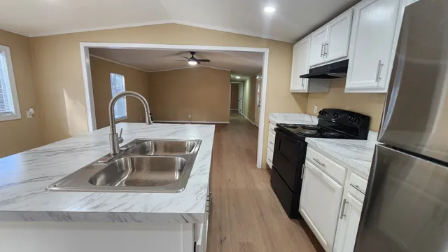 a kitchen with a sink a stove and refrigerator