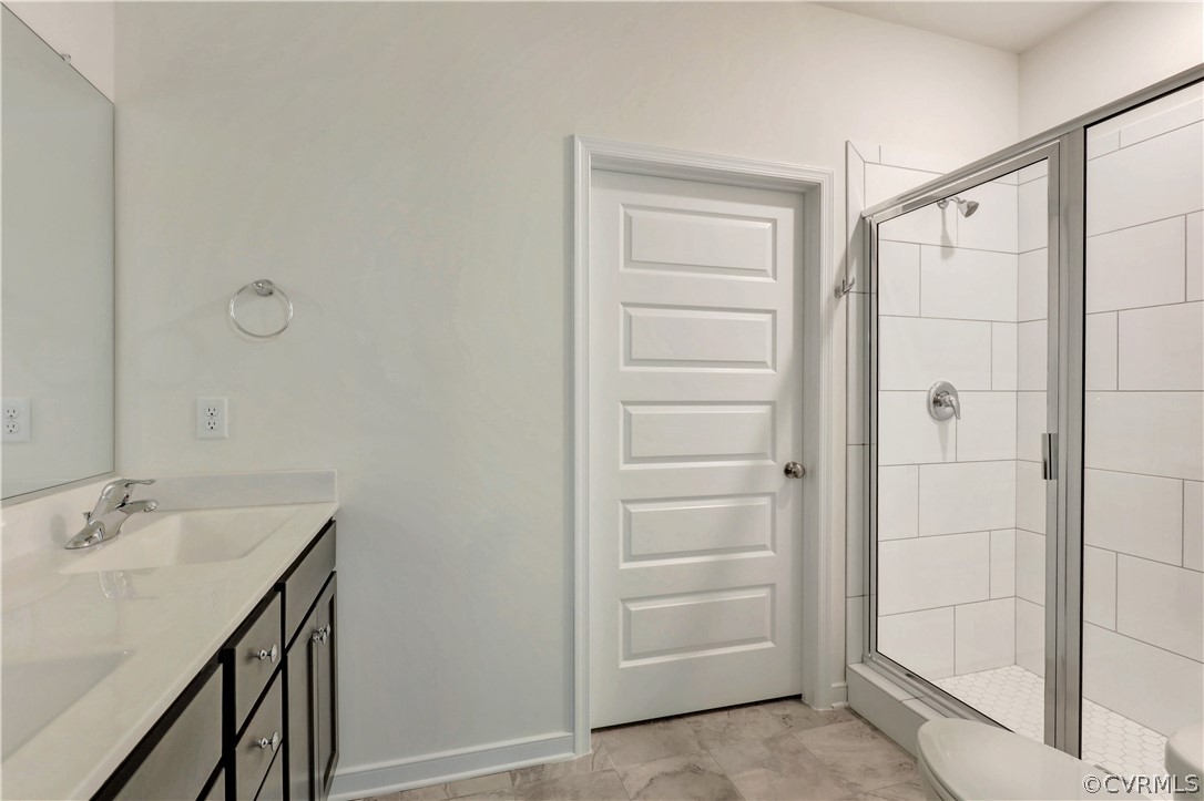 4208 Lind Lane Midlothian, VA 23112 - Photo 13 of 34 a bathroom with a shower sink and mirror