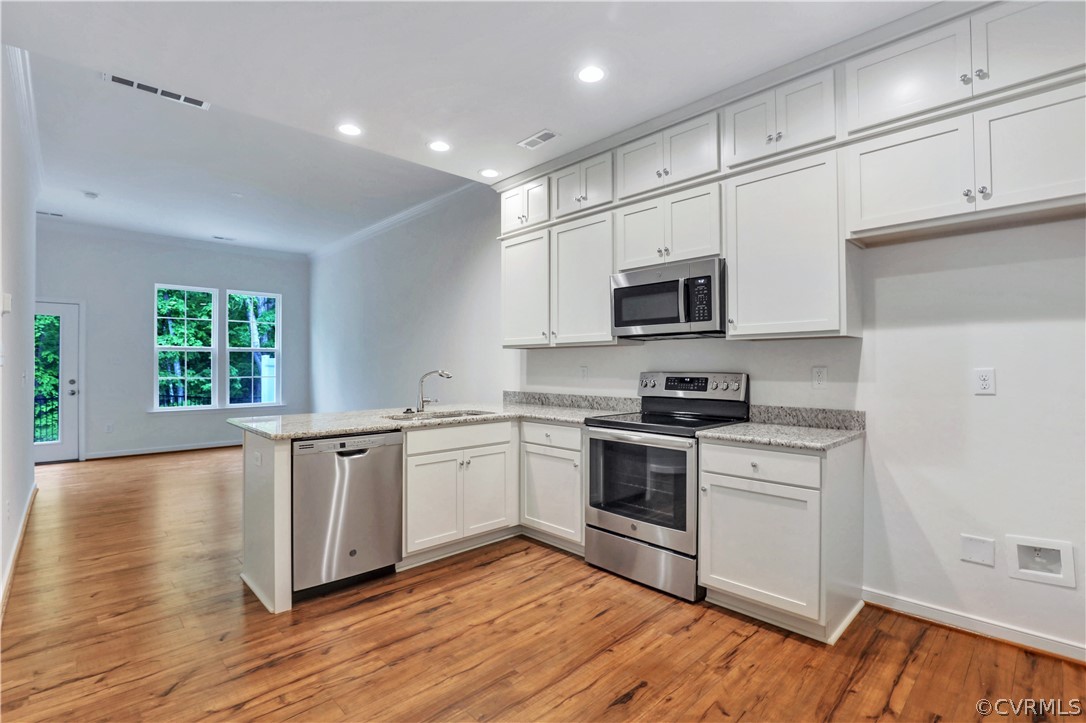 4208 Lind Lane Midlothian, VA 23112 - Photo 5 of 34 a kitchen with granite countertop a stove top oven sink and cabinets