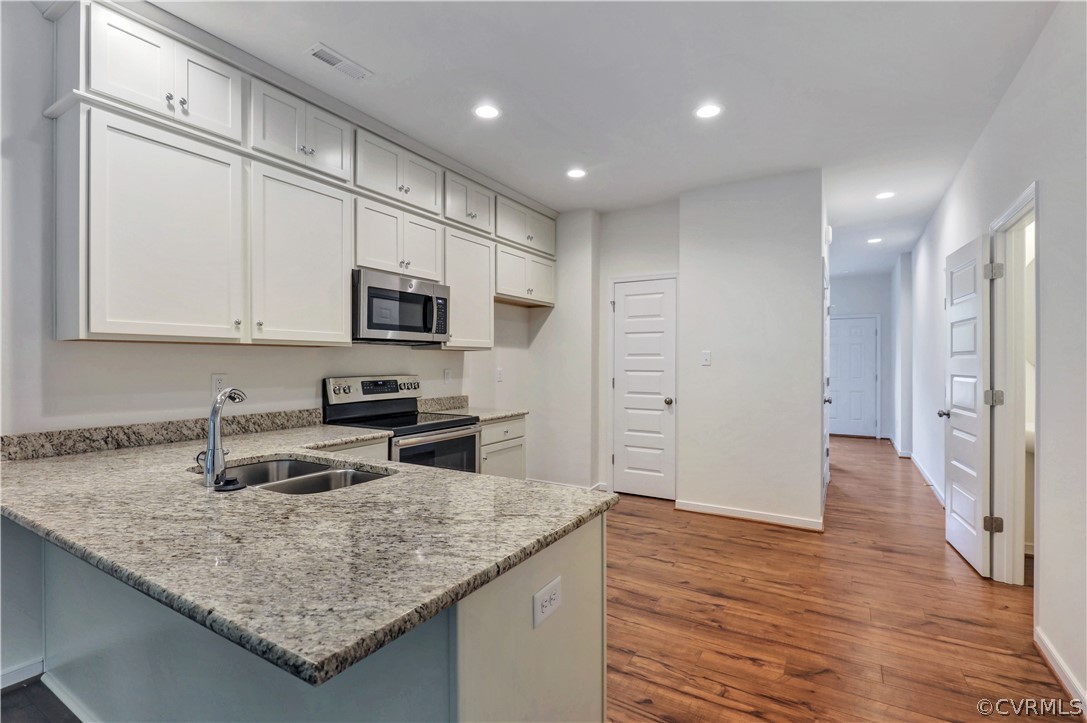 4208 Lind Lane Midlothian, VA 23112 - Photo 6 of 34 a kitchen with stainless steel appliances granite countertop a sink stove and refrigerator