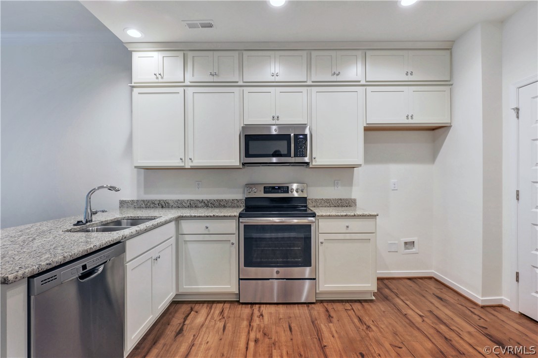 4208 Lind Lane Midlothian, VA 23112 - Photo 7 of 34 a kitchen with a stove and white cabinets