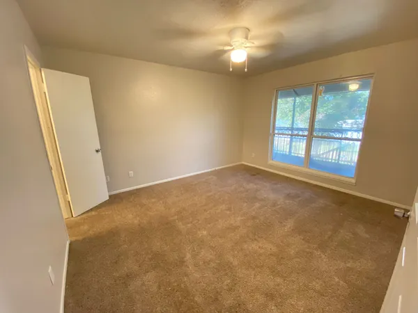 a bathroom with a granite countertop sink toilet a large mirror a bathtub and shower