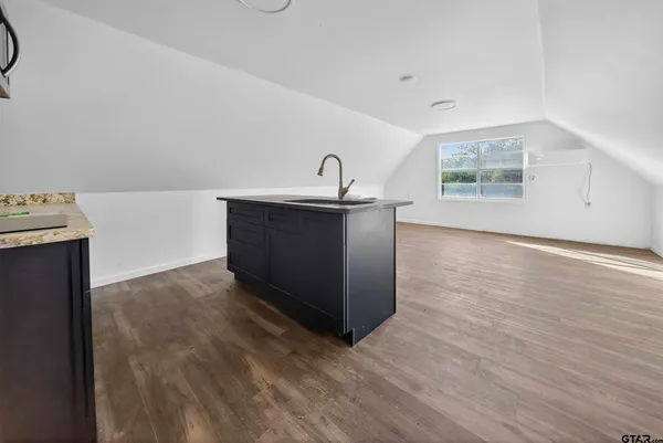 a room with wooden floors and white walls