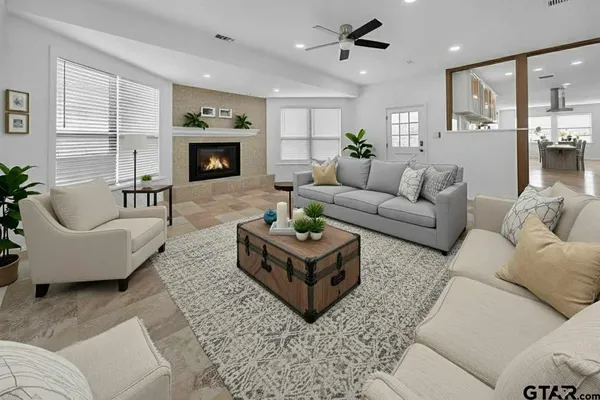 a living room with furniture and a fireplace
