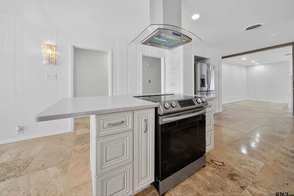 a kitchen with stainless steel appliances granite countertop a stove and a sink
