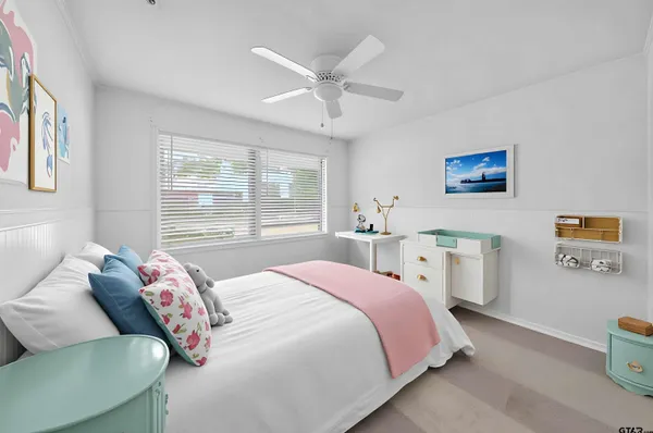 a bedroom with a bed and a large window