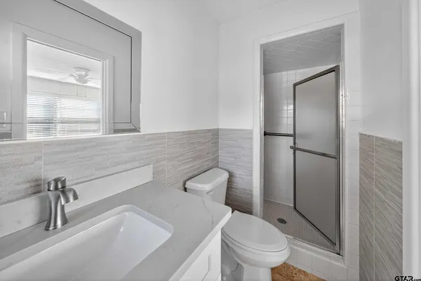 a bathroom with a toilet sink and shower