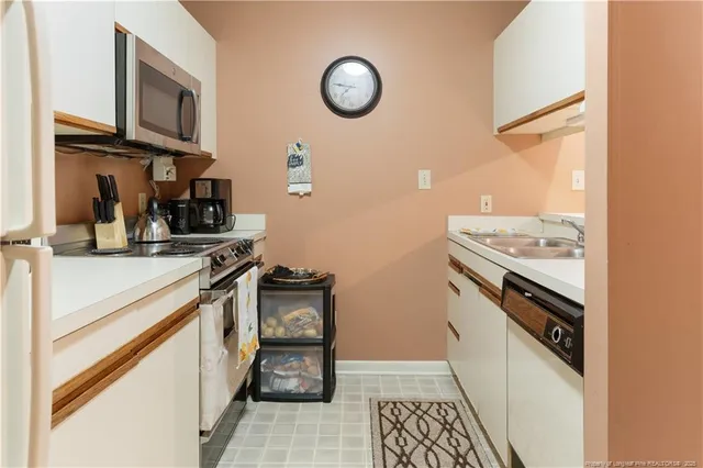 a kitchen with stainless steel appliances granite countertop a stove and a sink