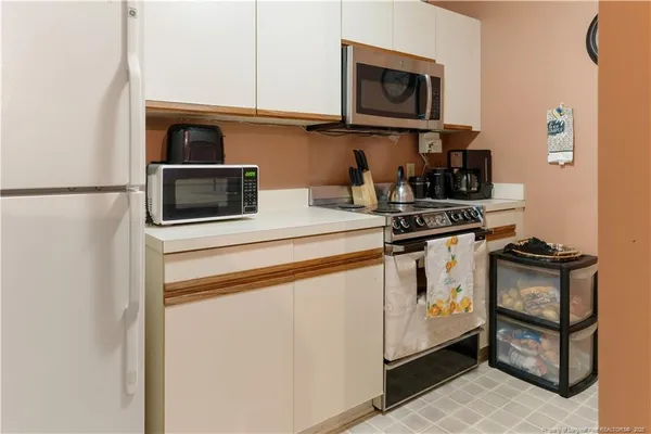 a kitchen with stainless steel appliances a stove a microwave and a refrigerator